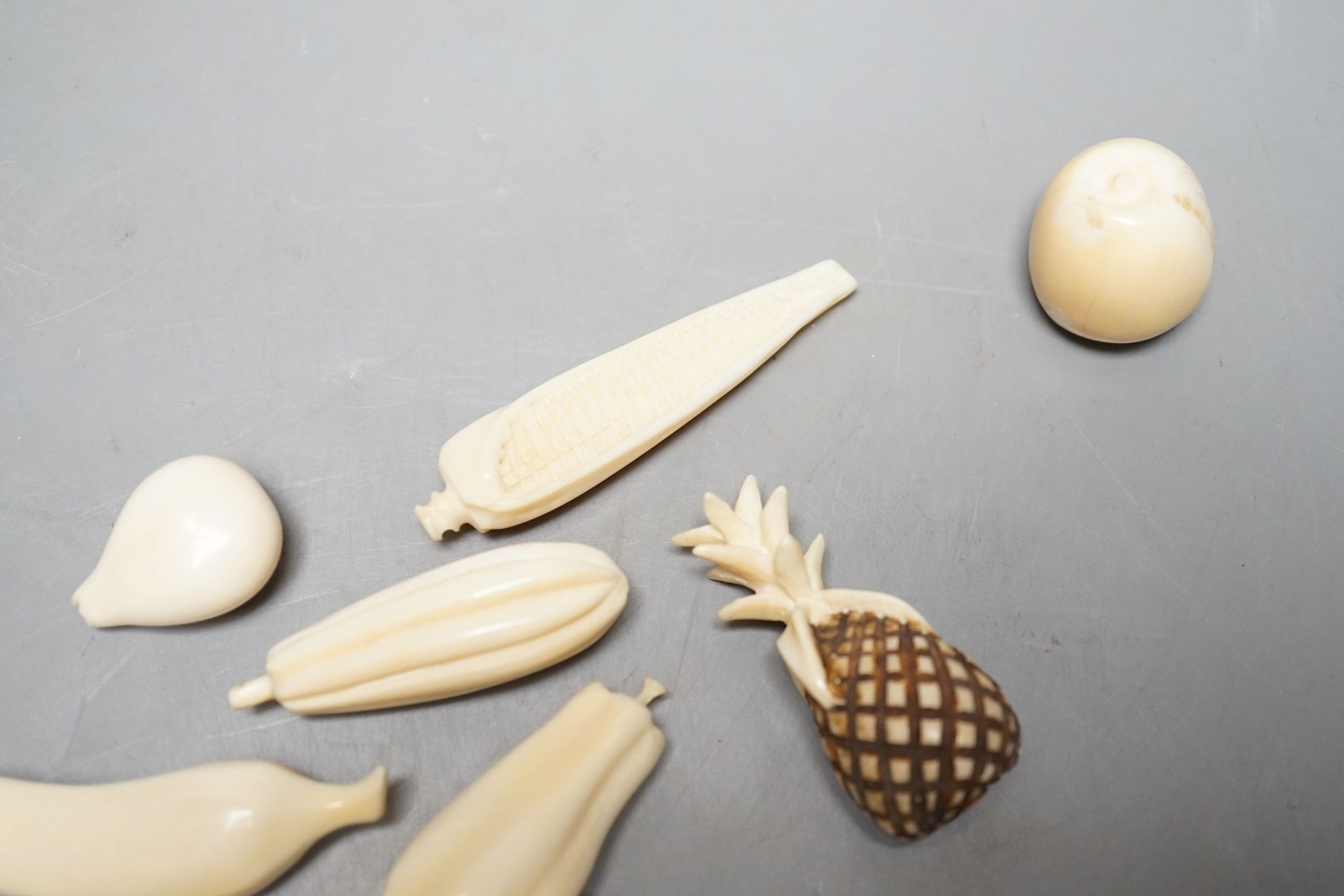 A group of Chinese carved ivory fruits, on ‘leaf’, 19cm